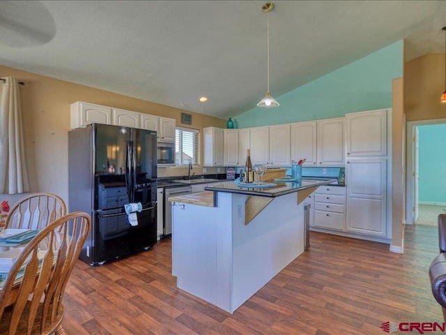 kitchen with dishwasher, a center island, white cabinets, black fridge, and hanging light fixtures