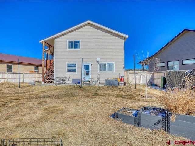 back of property with a patio area and a lawn