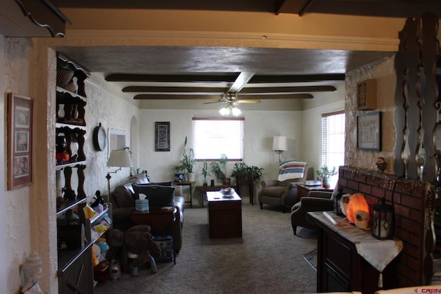 living room with beamed ceiling, a wealth of natural light, carpet flooring, and ceiling fan