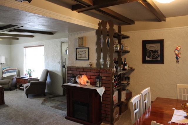 living room featuring ceiling fan, beamed ceiling, and carpet floors