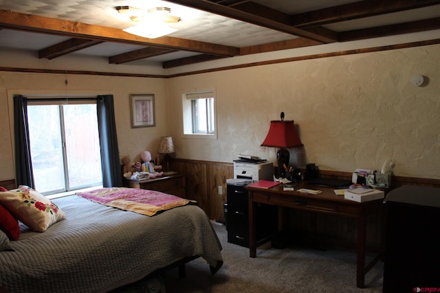 carpeted bedroom with beamed ceiling and multiple windows