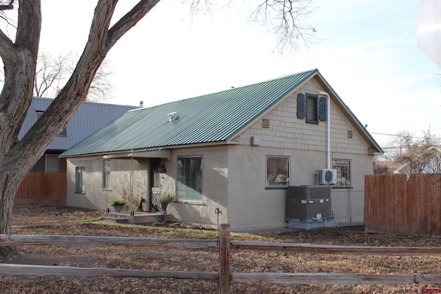 view of front of property with central AC unit and ac unit