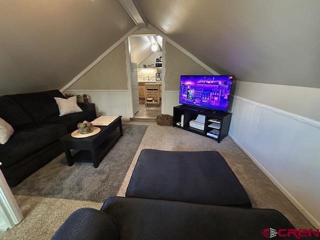 living room featuring carpet and lofted ceiling