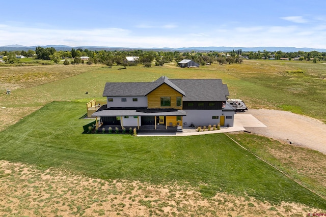 drone / aerial view featuring a mountain view and a rural view