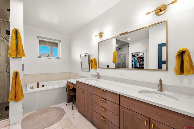 bathroom featuring vanity and independent shower and bath