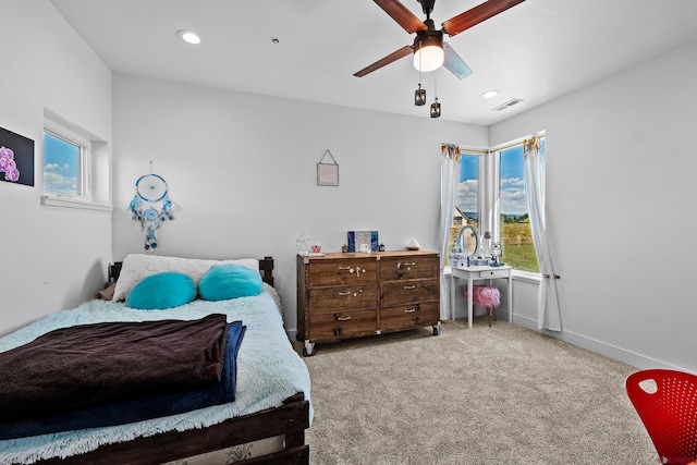 bedroom featuring multiple windows, ceiling fan, and carpet floors