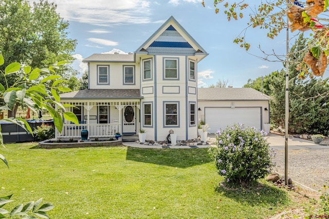 victorian house with a front yard, a porch, and a garage