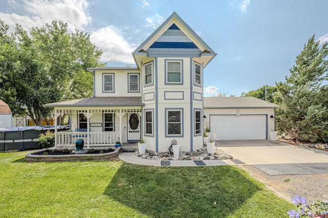 victorian house featuring a front yard, a porch, and a garage