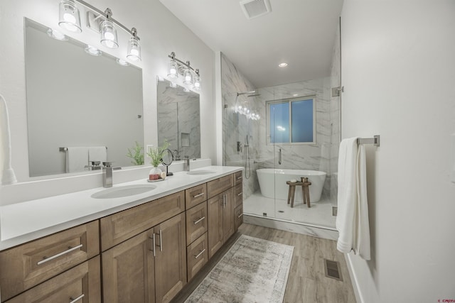 bathroom featuring vanity, wood-type flooring, and independent shower and bath