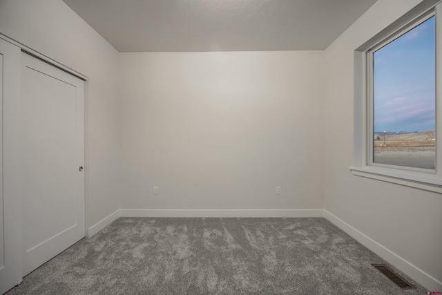 unfurnished room featuring carpet