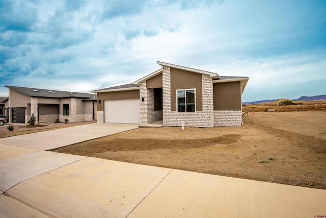 view of front facade with a mountain view and a garage