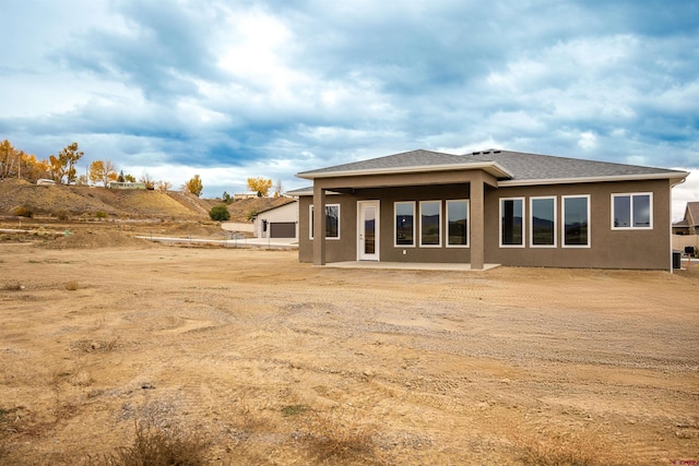 back of property featuring a patio