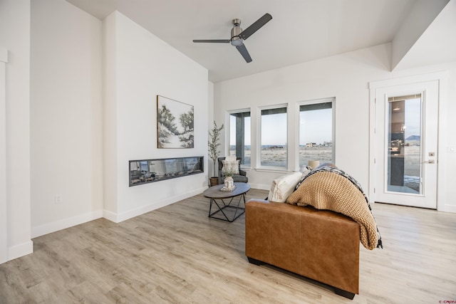 living room featuring light wood-type flooring and ceiling fan