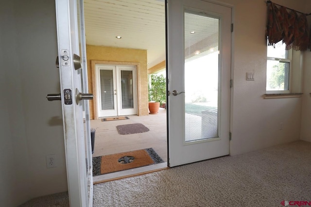 doorway with french doors and carpet floors