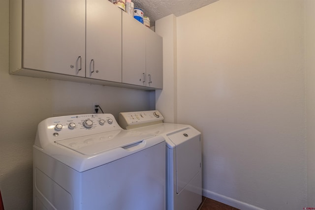 laundry room featuring cabinets, a textured ceiling, and independent washer and dryer