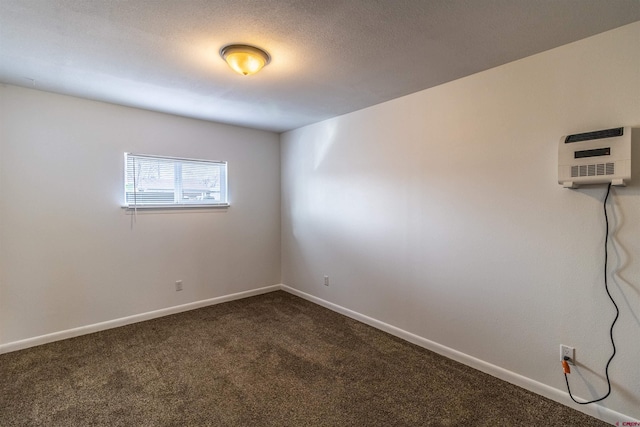 unfurnished room with a wall mounted AC and carpet