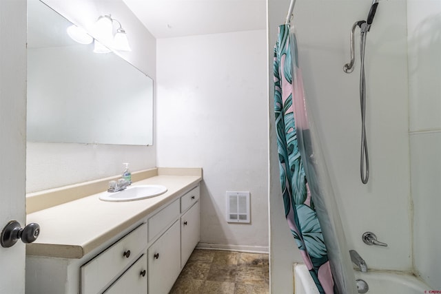 bathroom featuring shower / tub combo and vanity