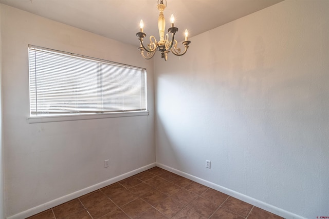 spare room featuring a notable chandelier