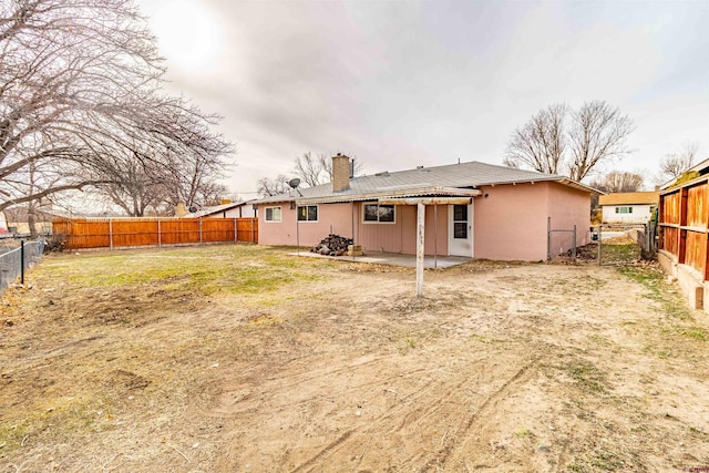 back of property featuring a yard and a patio