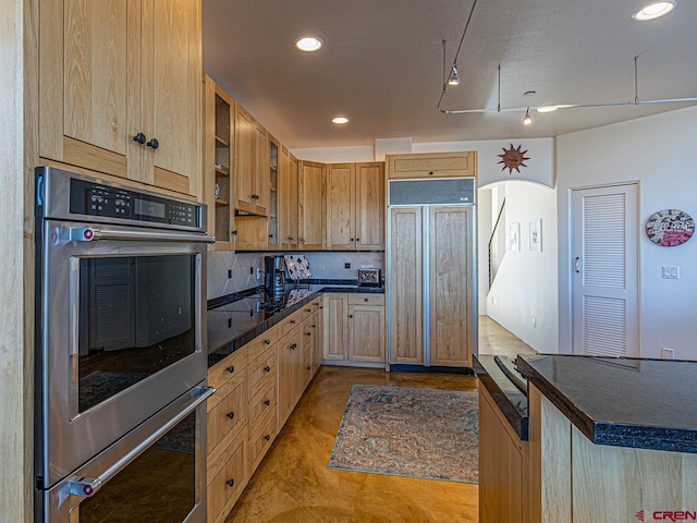kitchen with paneled built in fridge, light tile patterned flooring, tasteful backsplash, light brown cabinetry, and double oven