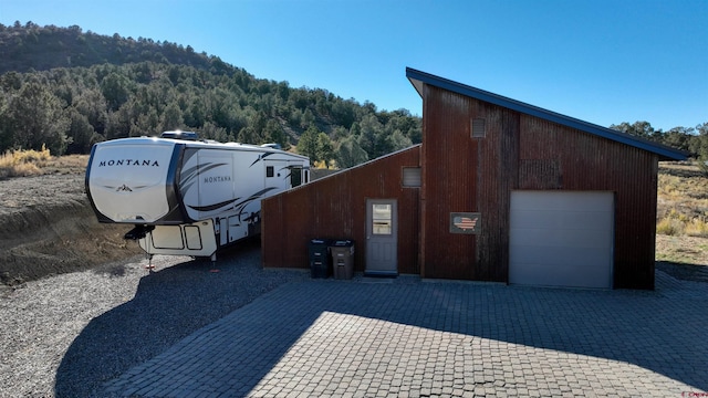 exterior space with a garage and an outdoor structure