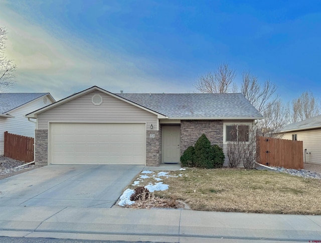 ranch-style house featuring a garage and a front lawn