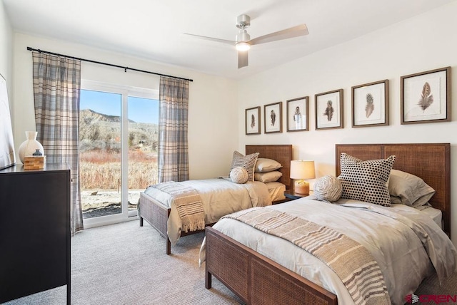 carpeted bedroom featuring access to exterior and ceiling fan