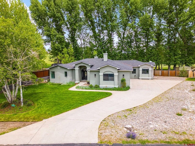 single story home featuring a front lawn