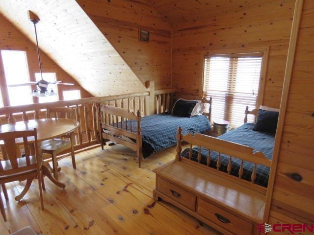 bedroom with light hardwood / wood-style flooring and lofted ceiling