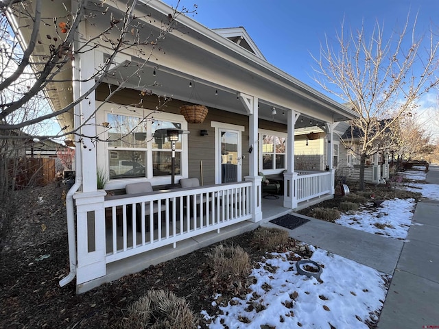 exterior space with covered porch and an outdoor fire pit