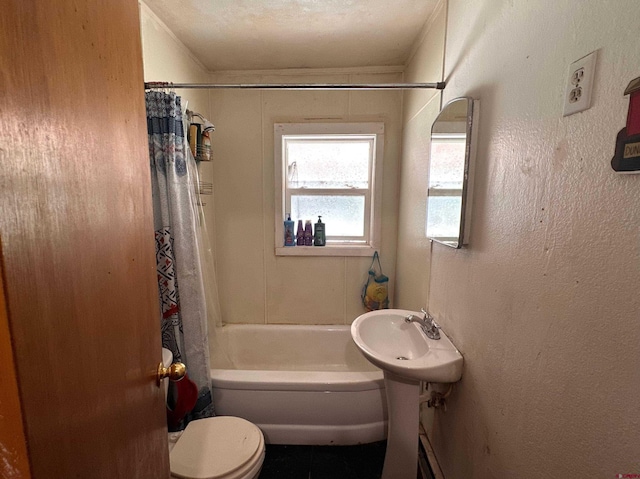 full bathroom featuring sink, toilet, shower / bathtub combination with curtain, and a textured ceiling