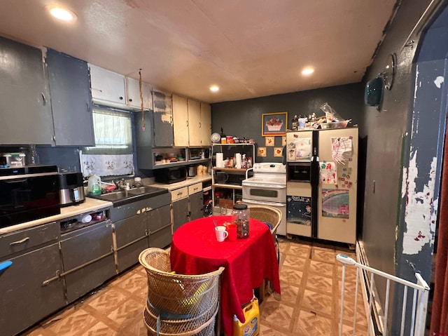 kitchen with stove, fridge with ice dispenser, and sink