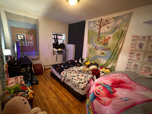 bedroom with wood-type flooring and a textured ceiling