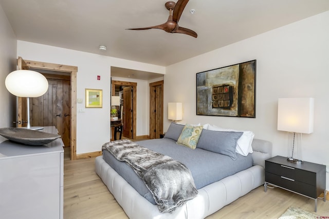 bedroom with ceiling fan and light wood-type flooring