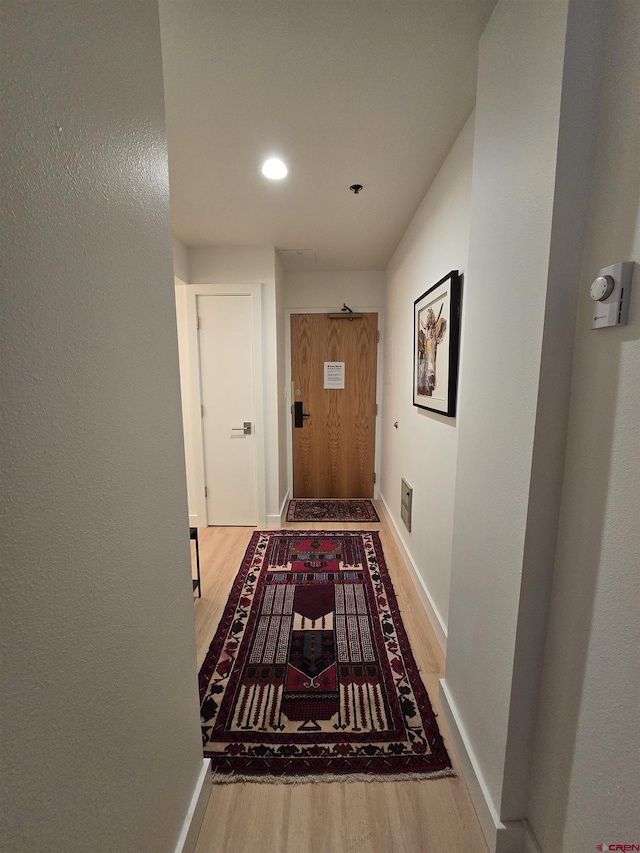 hallway with wood-type flooring