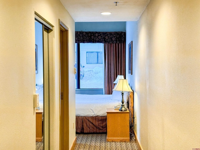 hallway with hardwood / wood-style flooring