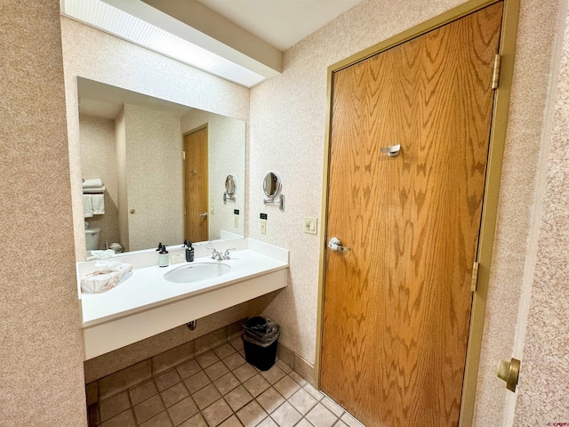 bathroom featuring tile patterned floors, toilet, and sink