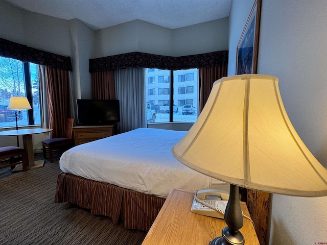 bedroom with carpet flooring and a textured ceiling