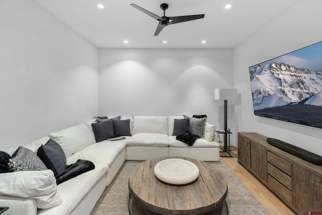 living room with ceiling fan and light hardwood / wood-style floors