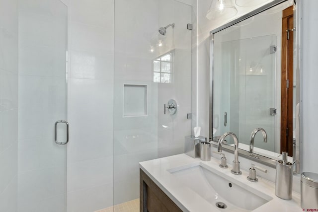 bathroom featuring vanity and an enclosed shower