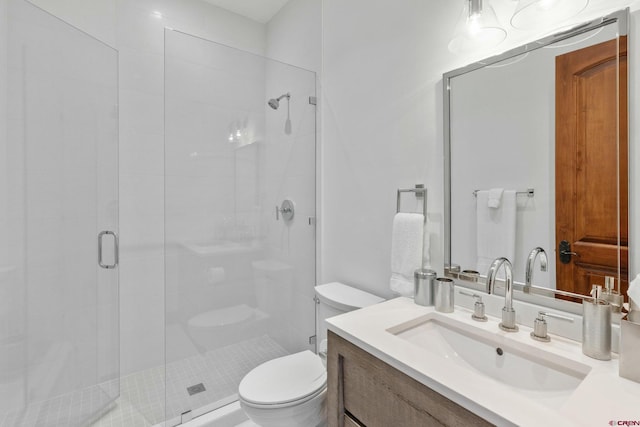 bathroom with vanity, toilet, and a shower with shower door