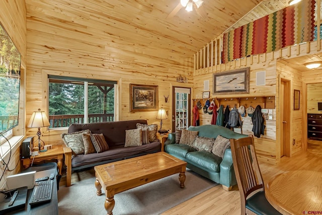 living room featuring high vaulted ceiling, ceiling fan, wooden ceiling, and wooden walls