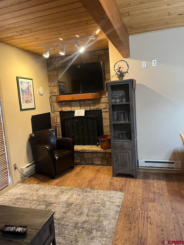 living room featuring hardwood / wood-style floors, a fireplace, baseboard heating, beamed ceiling, and wood ceiling