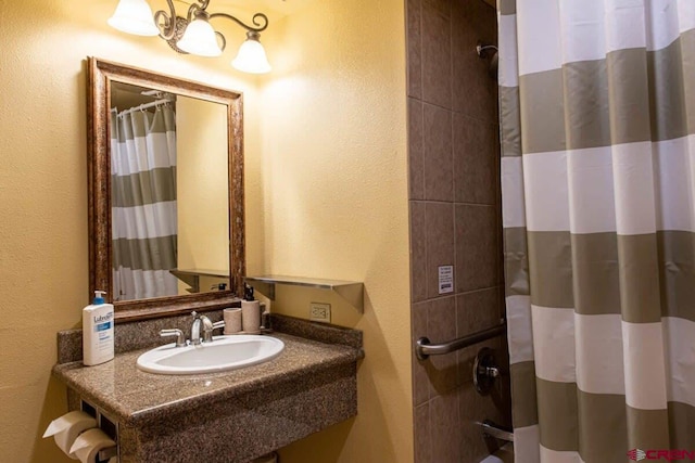 bathroom featuring walk in shower and sink