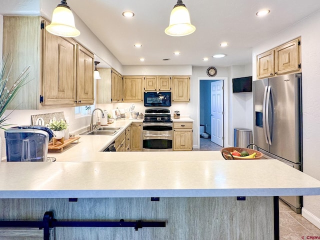 kitchen with a breakfast bar, pendant lighting, stainless steel appliances, and sink