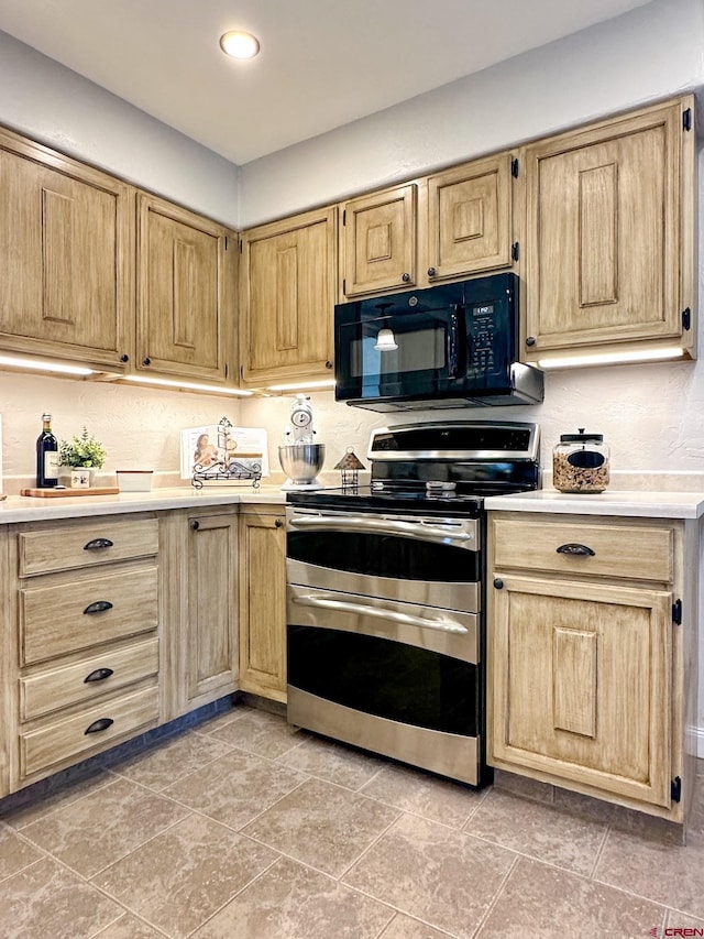 kitchen with light brown cabinetry and double oven range