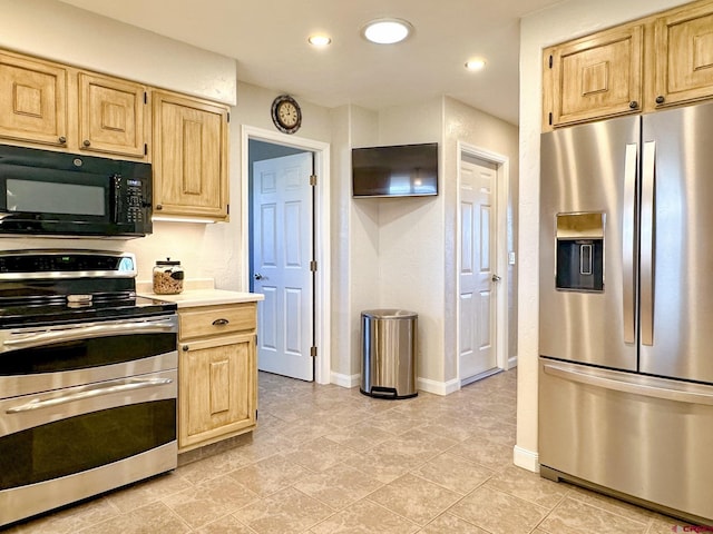 kitchen featuring stainless steel appliances and light brown cabinetry