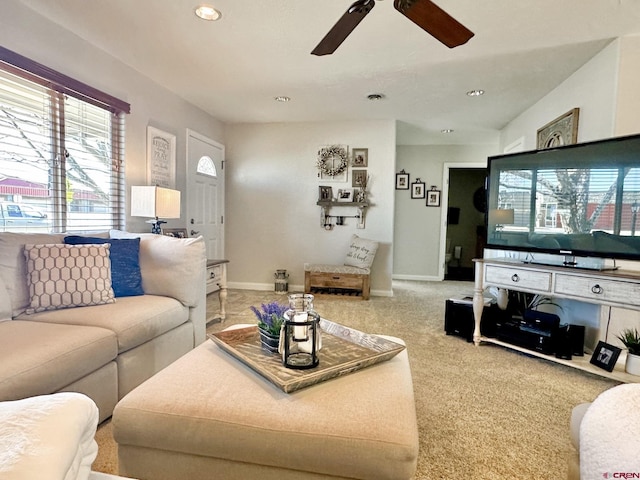 carpeted living room featuring ceiling fan