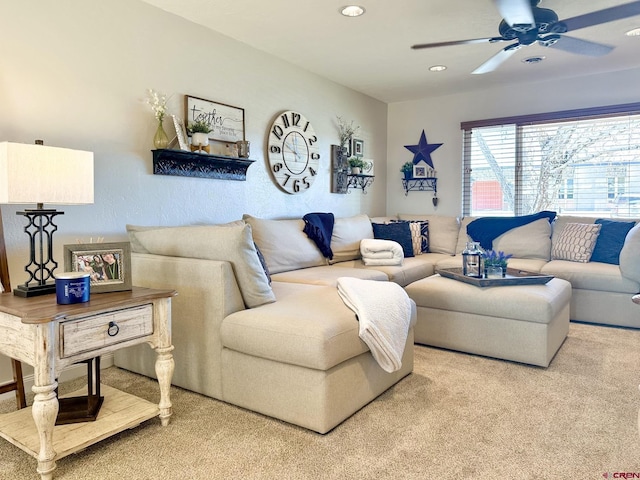 carpeted living room with ceiling fan