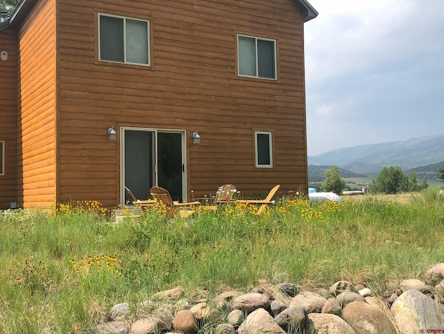 back of property featuring a mountain view